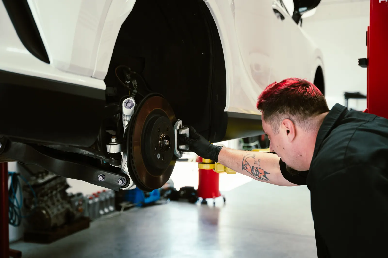 Exposed brake rotor and caliper during brake repair service in Escondido, CA