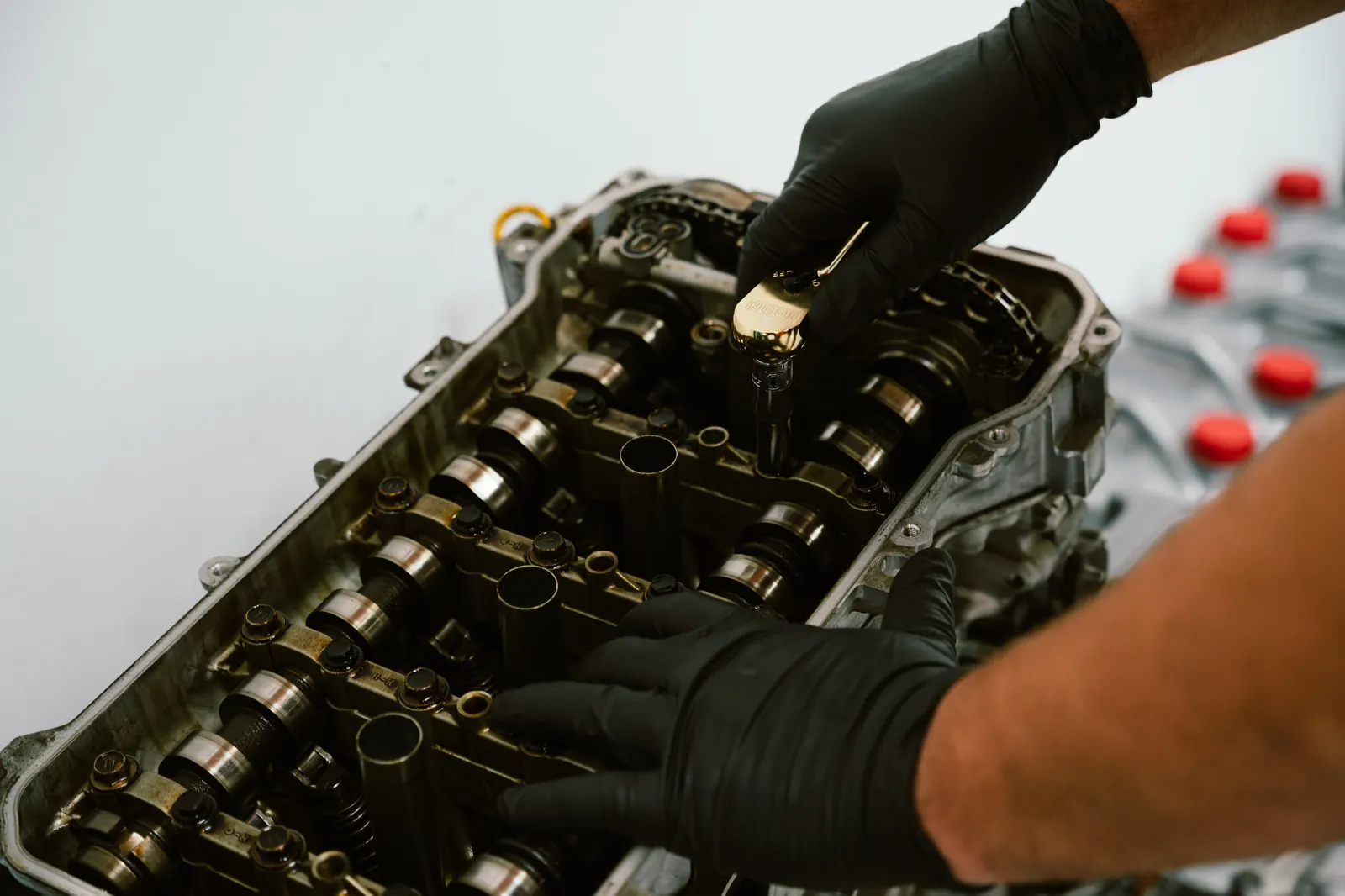 Mechanic performing engine valve cover repair in Escondido, CA