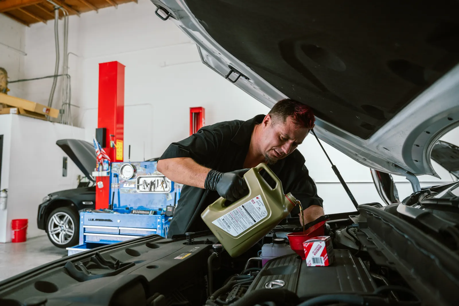 Mechanic performing vehicle maintenance service in Escondido, CA